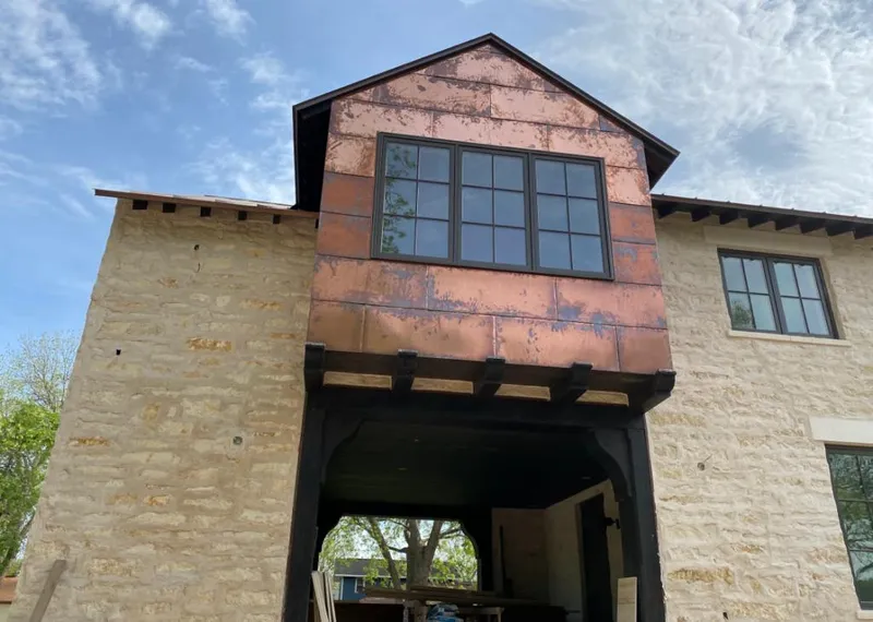 Copper metal panel facade on a stone building for Skylight Installation in Greenville